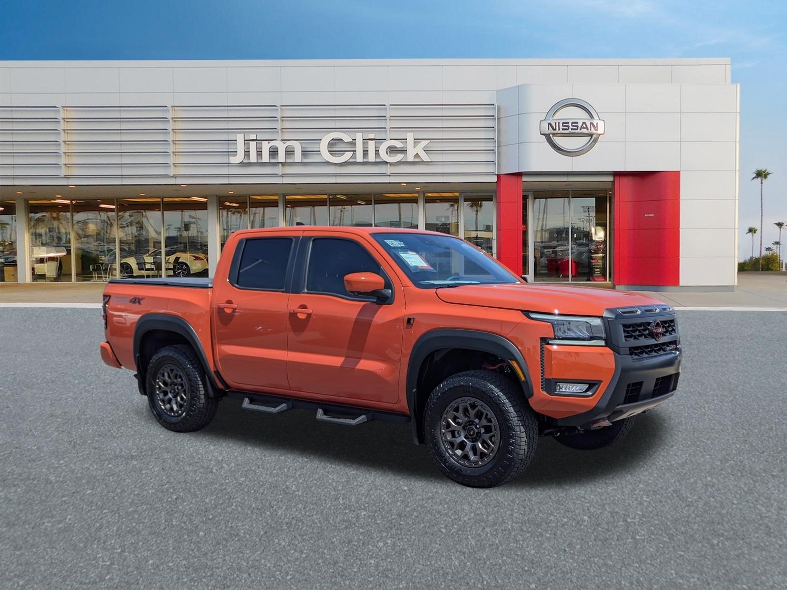 2026 Nissan Frontier PRO-4X w/R Package in Afterburn Orange — front three-quarter view